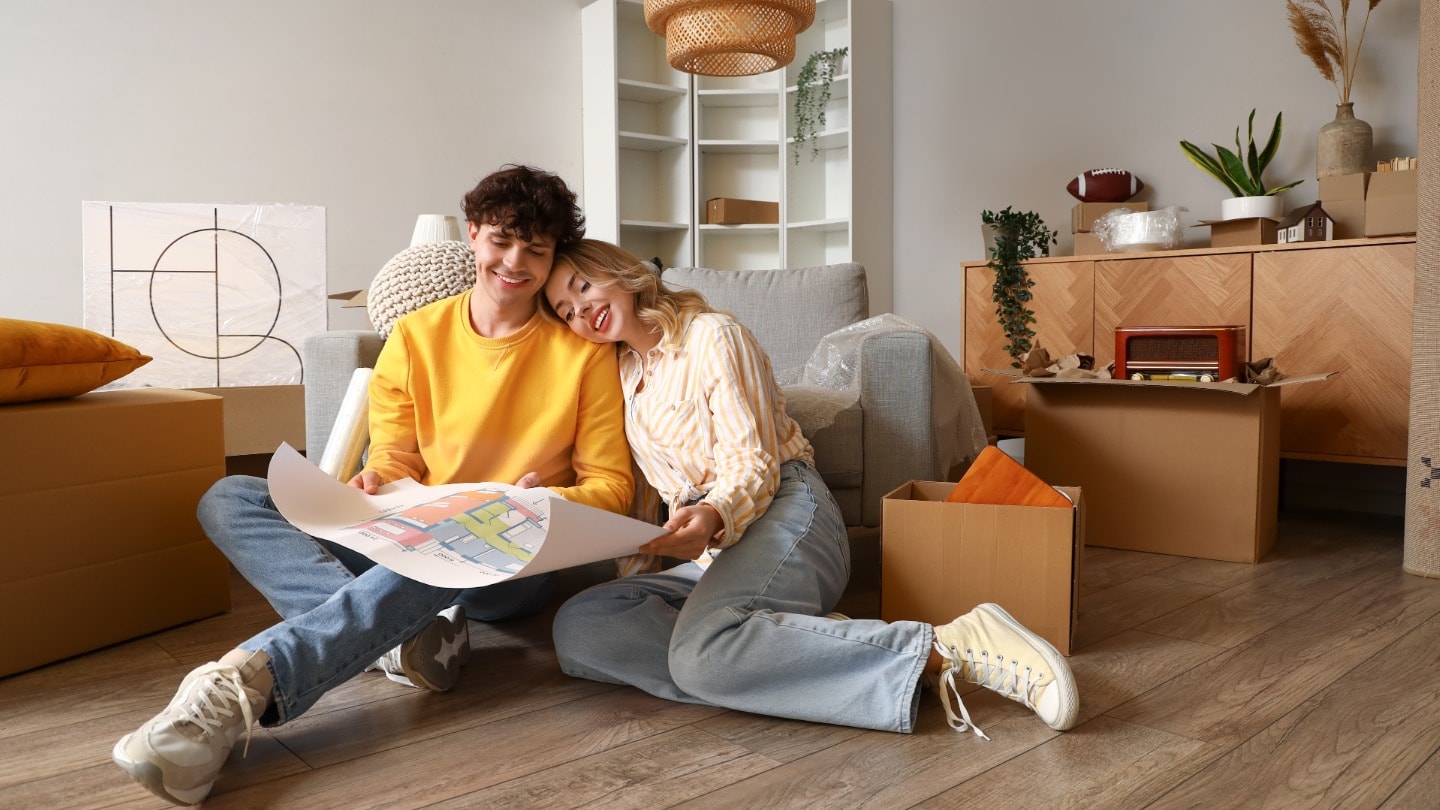 Young couple reviewing plans for their new home